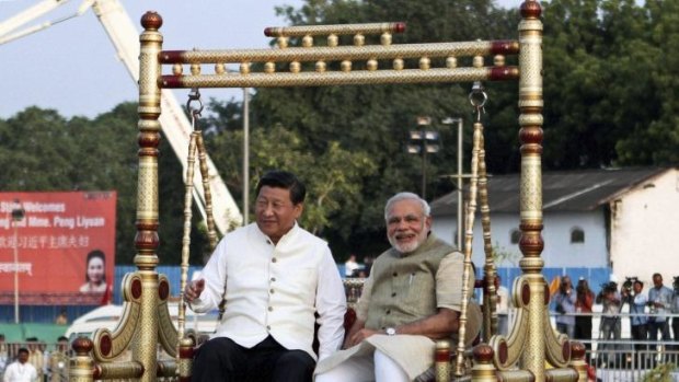Chinese President Xi Jinping and Indian Prime Minister Narendra Modi sit on a traditional swing by the Sabarmati River in Ahmedabad.