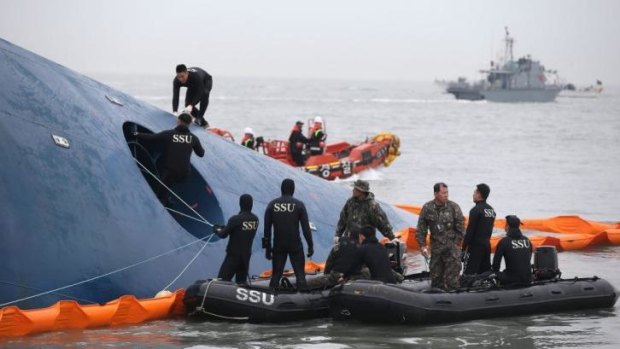 South Korean rescue team members search for passengers aboard the capsized ferry.