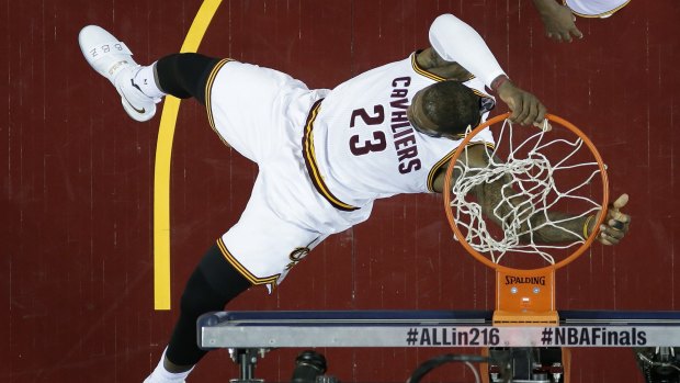 Spectacular: Cleveland Cavaliers forward LeBron James dunks against the Golden State Warriors during Game 6 of the NBA Finals in Cleveland.
