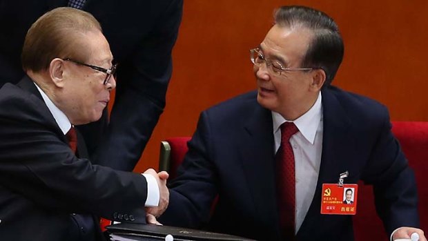 The reformist Premier, Wen Jiabao, right, shakes hands with the party elder Jiang Zemin.