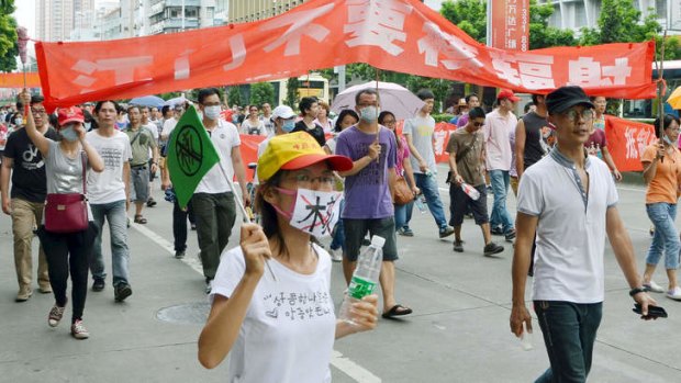 Opposition: Hundreds of banner-carrying protesters who oppose the uranium processing plant paraded through Jiangmen city.