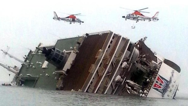 Rescue helicopters fly over the stricken ferry searching for survivors.