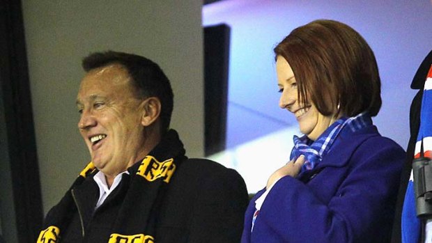 Prime Minister Julia Gillard and Tim Mathieson enjoy the match.