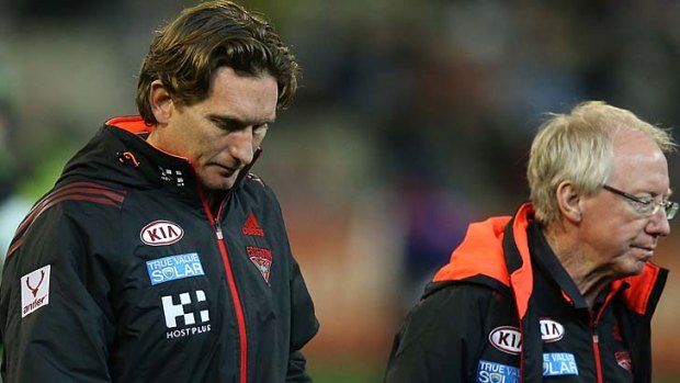 Bombers coach James Hird walks off the MCG with Dr Bruce Reid (R) on Sunday.