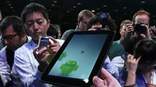 Reporters look at a prototype of an Android tablet computer using Medfield Intel chips during the 2011 Intel Developer Forum at Moscone Center on September 13, 2011 in San Francisco, California.