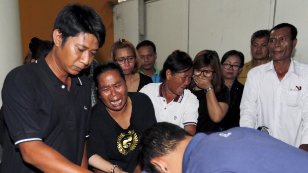 Relatives cry as they remove the body of Suwan Sudmun, a Thai victim of Monday's bomb blast.