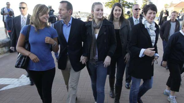Opposition Leader Tony Abbott casts his vote with wife Margie and daughters (left to right) Francis, Bridget and Louise, at the Queenscliff Surf Lifesaving Club in his seat of Warringah yesterday. <i>Picture: Glen McCurtayne</i>