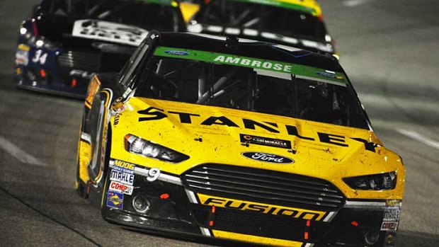 Marcos Ambrose leads a pack of cars during the NASCAR Sprint Cup Series at Richmond International Raceway.