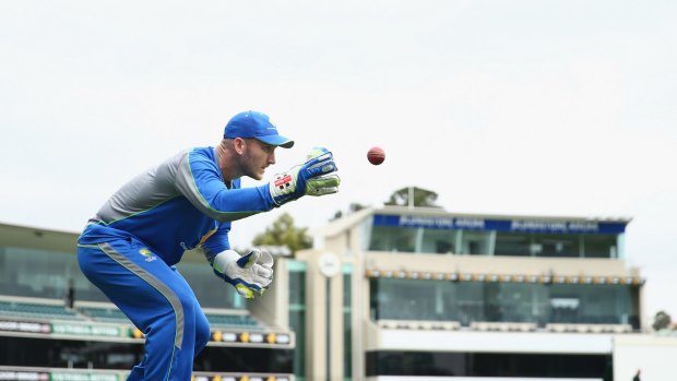 Venue fight: Australian wicketkeeper Peter Nevill takes the ball during an Australian nets session at Blundstone Arena.