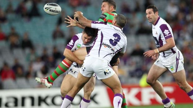 Larger than life: Sam Burgess offloads in the tackle.