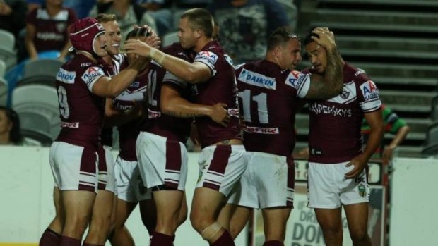Band of brothers: Manly celebrate Cheyse Blair's opening try at Bluetongue Stadium.