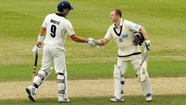 Chris Rogers (right) celebrates with Cameron White after scoring a century.