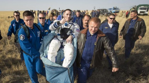 Home to rest ... Expedition 36 Flight Engineer Chris Cassidy of NASA is carried to the medical tent shortly after  landing in their Soyuz TMA-08M capsule on September 11, 2013.
