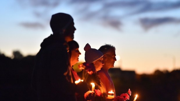 People pay their respect to Justine Damond at Freshwater Beach during a vigil on Wednesday.