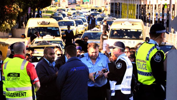 Taxi drivers blockade the entrance to Melbourne airport on Monday morning in a disupe over cab rank changes.