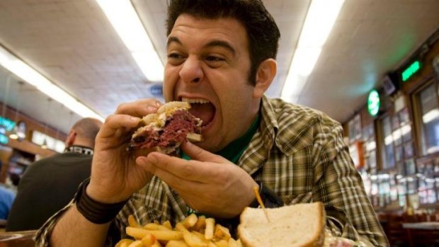 On the hunt: A New York sandwich finds its way into Adam Richman's mouth in <i>Man Finds Food</i>.
