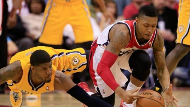 Pacers star Paul George and Wizards guard Bradley Beal scramble for the ball.