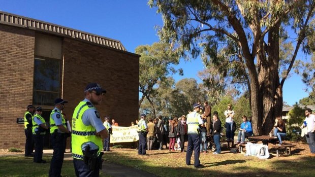 Armed police officers greeted protesters at Australian National University's (ANU) Acton campus.