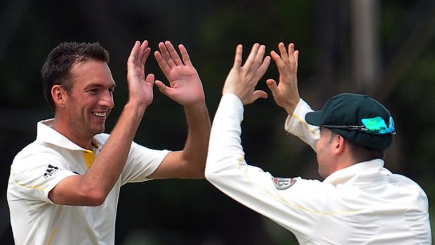 Trent Copeland (left) celebrates with Michael Clarke after taking a wicket against the Sri Lankan board XI.