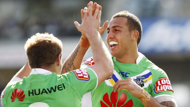 Blake Ferguson and Glen Buttriss of the Raiders celebrate a try during the round six NRL match between the Canberra Raiders and the New Zealand Warriors.