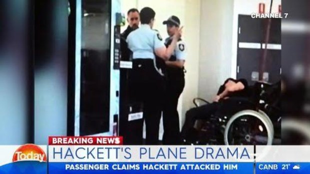 This image purports to show Grant Hackett slumped over next to police at Melbourne Airport.