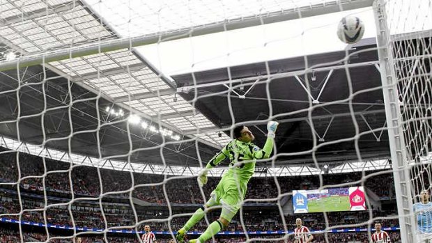 Sunderland's goalkeeper Vito Mannone  dives in vain to stop a wonder strike by Manchester City's Yaya Toure.