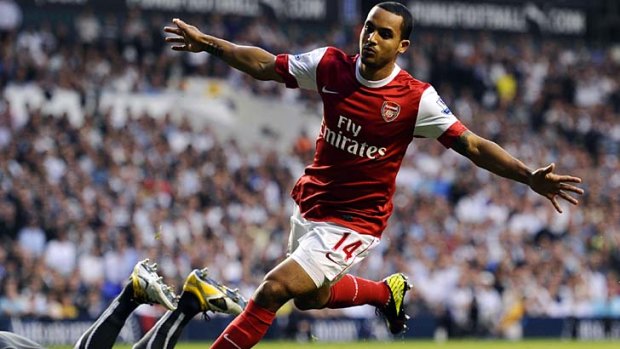They think it's all over: Arsenal's Theo Walcott celebrates a goal against Spurs, but Tottenham struck back to draw 3-3.