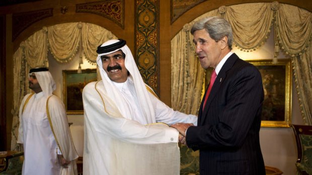 Balancing act: US Secretary of State John Kerry is greeted by Qatari Emir Hamad bin Khalifa Al Thani.