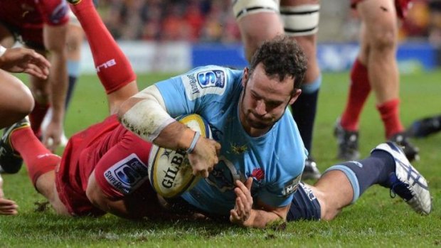 Five points, thank you: Jono Lance scrambles over for the Waratahs against the Reds.