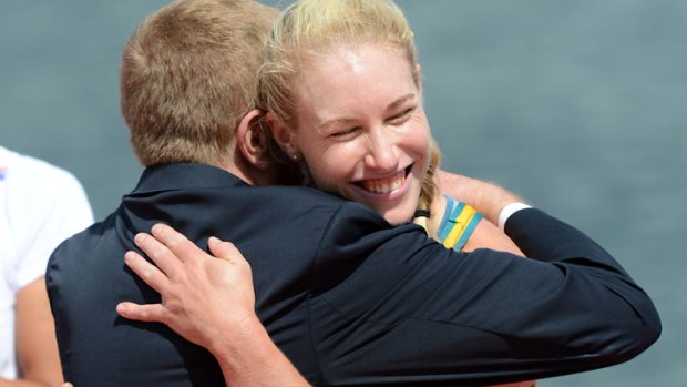 Australia's Kim Crow wins bronze in the women's single sculls and receives her medal from John Coates.
