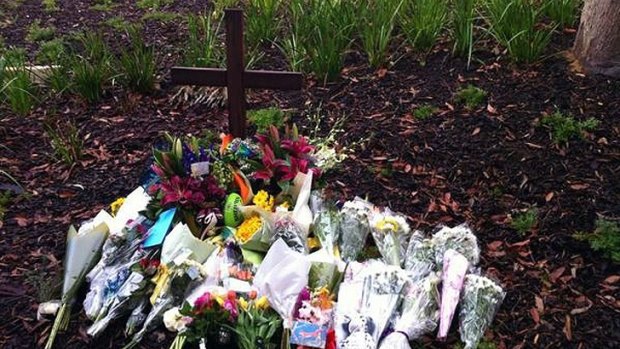 Tributes were placed at a cross erected at Scotch College today.