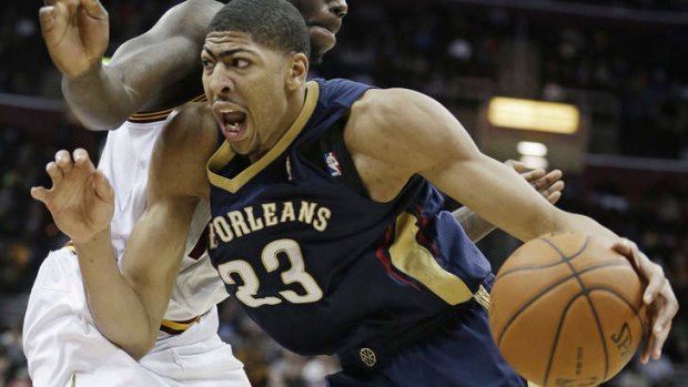 New Orleans Pelicans forward Anthony Davis drives past Cleveland Cavaliers opponent Anthony Bennett.