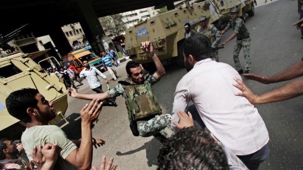 Protesters clash with Egyptian military outside the Defense Ministry in Cairo.