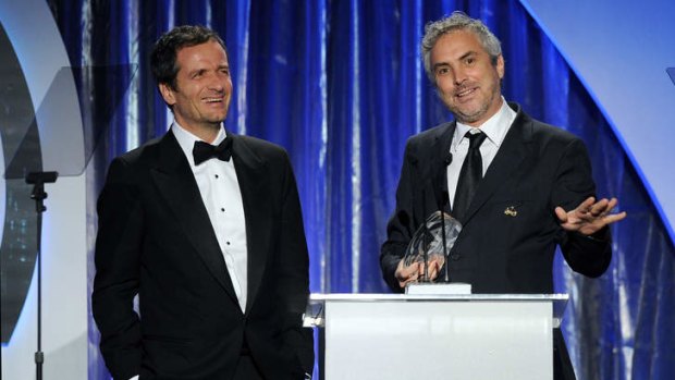 <i>Gravity</i> producer David Heyman (left) and director-producer Alfonso Cuaron accept the Darryl F. Zanuck Award for outstanding producer.