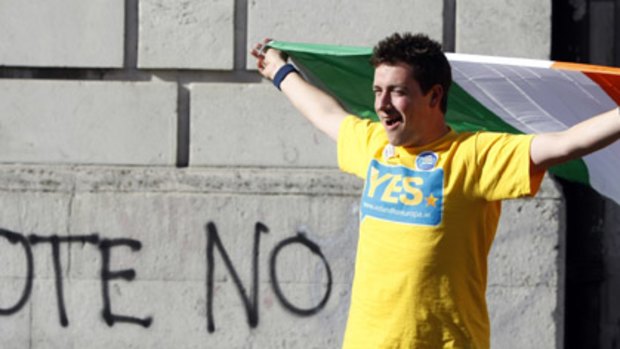 Change of heart... a supporter of the Lisbon Treaty cheers outside Dublin Castle after the result of the referendum was announced.