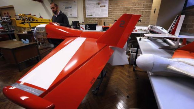 Salah Sukkarieh, professor of Robotics and Intelligent Systems at the University of Sydney, Australian Centre for Field Robotics, stands next to one of his robotic aircraft in his laboratory in Sydney