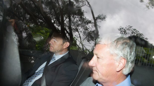 Bill Spedding is taken from his Bonny Hills home by detectives on Wednesday. 