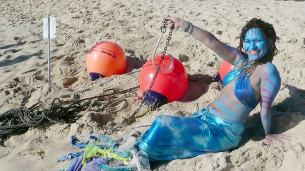 Kush Ayck dressed as a mermaid on beach