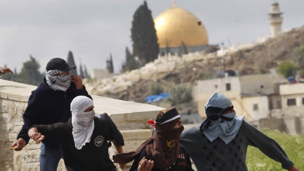Palestinian demonstrators throw stones at Israeli troops in east Jerusalem.