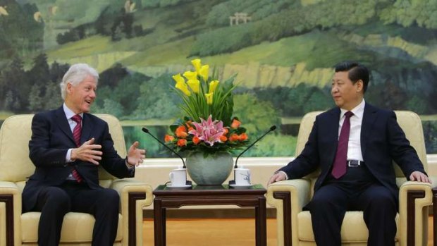 Bill Clinton speaks to Chinese President Xi Jinping during a meeting at the Great Hall of the People in Beijing on Monday.