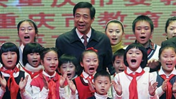 Populist: Bo Xilai with Chongqing students. His trial over bribes, embezzlement and abuses of power is expected to start within weeks.