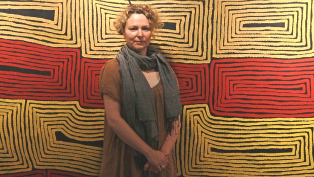 Temporary home: Lane Cove Council gallery manager Felicity Martin with Ronnie Tjampitjinpa's Tarrkunya, now at Gallery Lane Cove. It will soon be moved to a library.