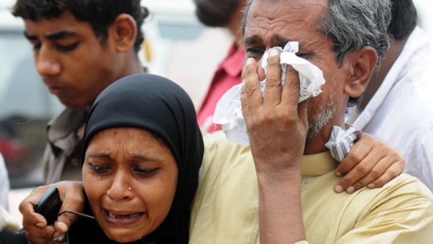 Grief &#8230; relatives of workers killed in Karachi.