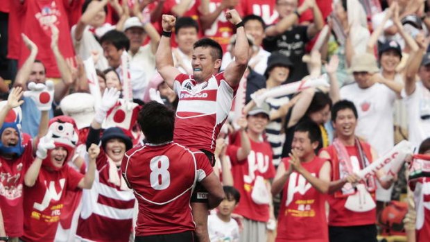 Committed: Japan celebrate their win against Wales in an international friendly at Prince Chichibu Stadium in June.