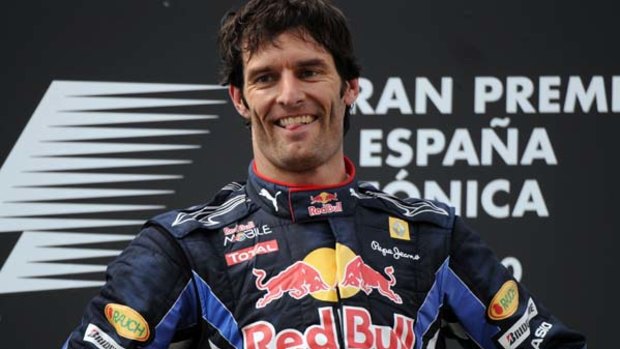 Mark Webber celebrates on the podium of the Circuit de Catalunya .