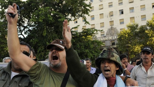 No drilling ... Argentine war veterans chant and wave anti-British  slogans including ‘‘Englishmen go home’’   in Buenos Aires.