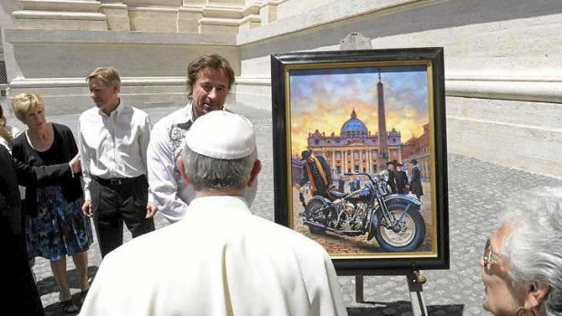 High on the hog: The pontiff is presented with a painting of a motorcycle in Saint Peter's Square.
