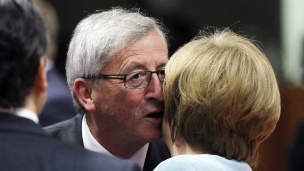 ''Not unheated '' ... Luxembourg's Prime Minister Jean-Claude Juncker greets Germany's Angela Merkel at the Brussels talks.
