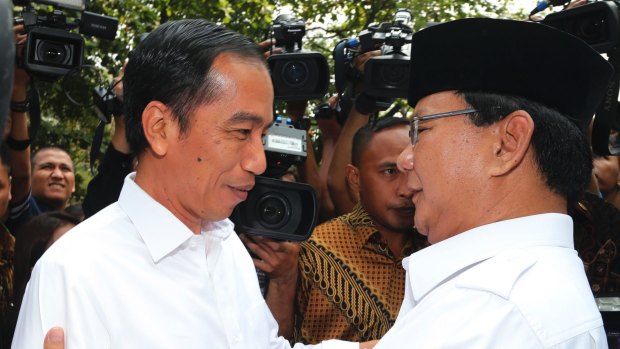 Joko Widodo embraced by his political rival Prabowo Subianto last year. 