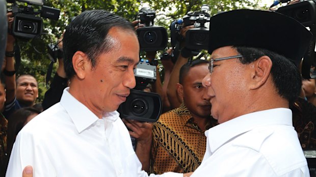 Joko Widodo embraced by his political rival Prabowo Subianto last year. 